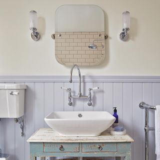 bathroom with basin and steel taps with mirror