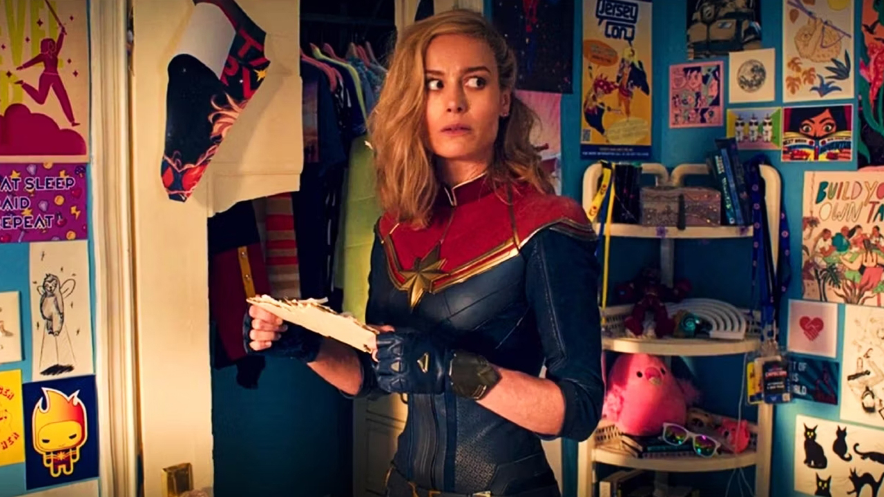 Captain Marvel standing confused in Kamala Khan's bedroom-Ms Marvel.