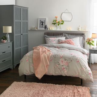 bedroom with floral bedding and grey cupboards
