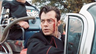 Jack Bannon as Alfred Pennyworth, bloody and concerned, in a car in Pennyworth