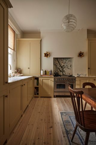Kitchen with magnolia Shaker-style units and off-white walls