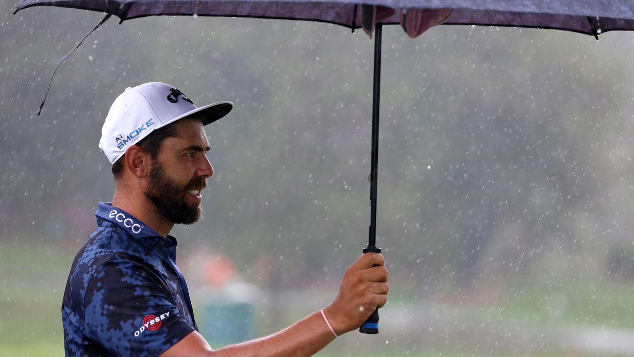 Erik van Rooyen holds up an umbrella at the 2024 Wyndham Championship