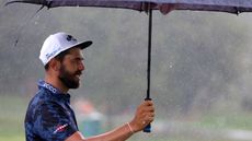 Erik van Rooyen holds up an umbrella at the 2024 Wyndham Championship