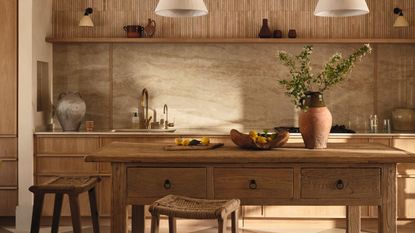 a rustic oak kitchen with freestanding kitchen island, woven stools and plaster pendant lights