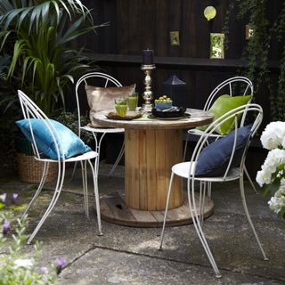 garden with round drum table and metal chairs