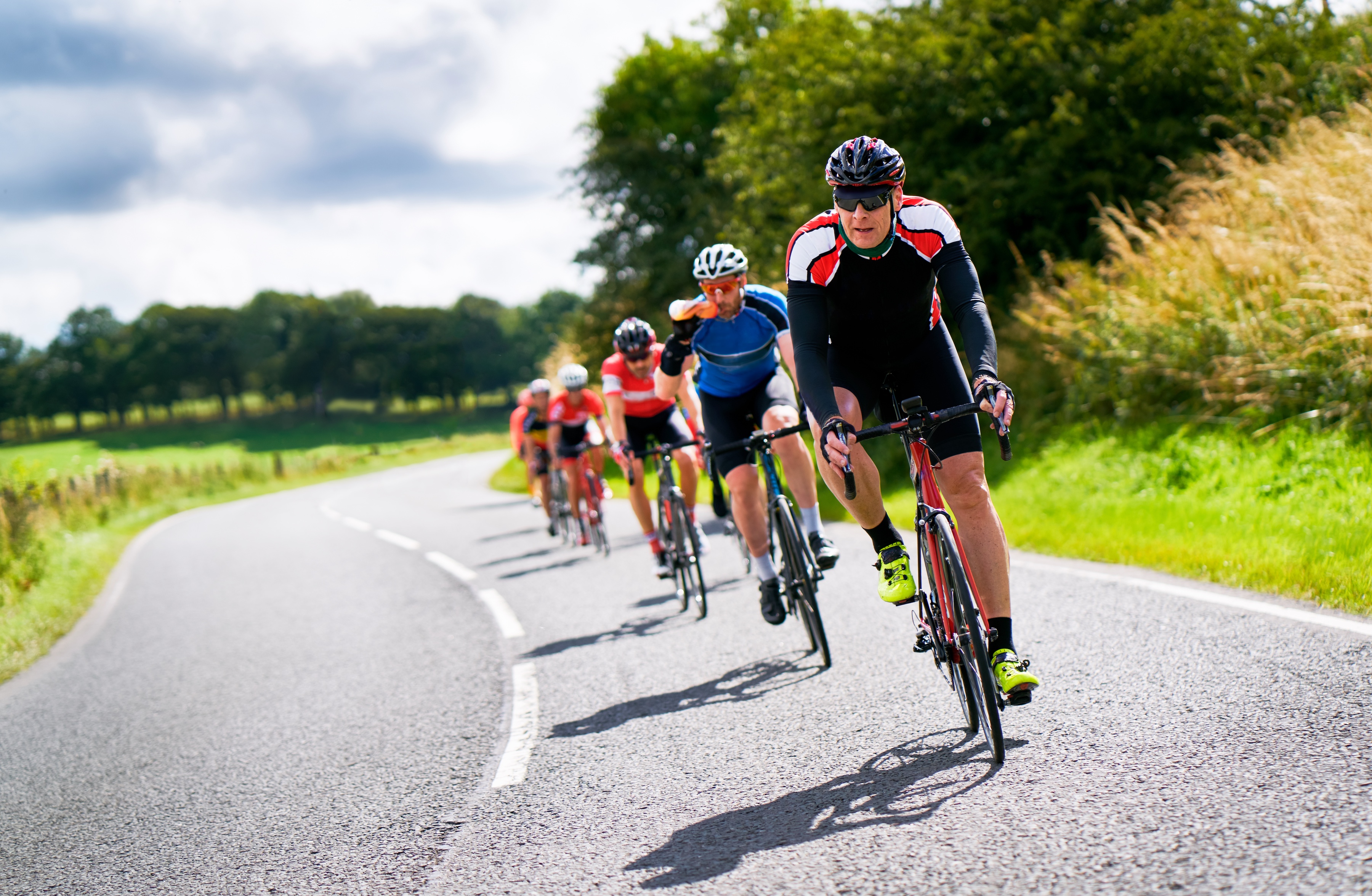 Group of male cyclists on UK country road