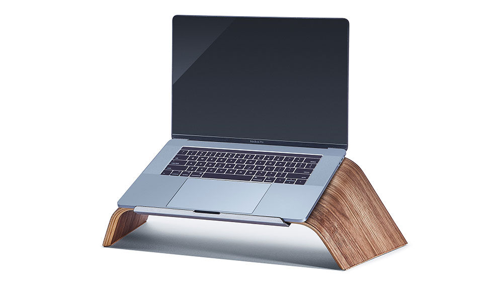 The Grovemade Walnut Laptop Stand holding a MacBook.