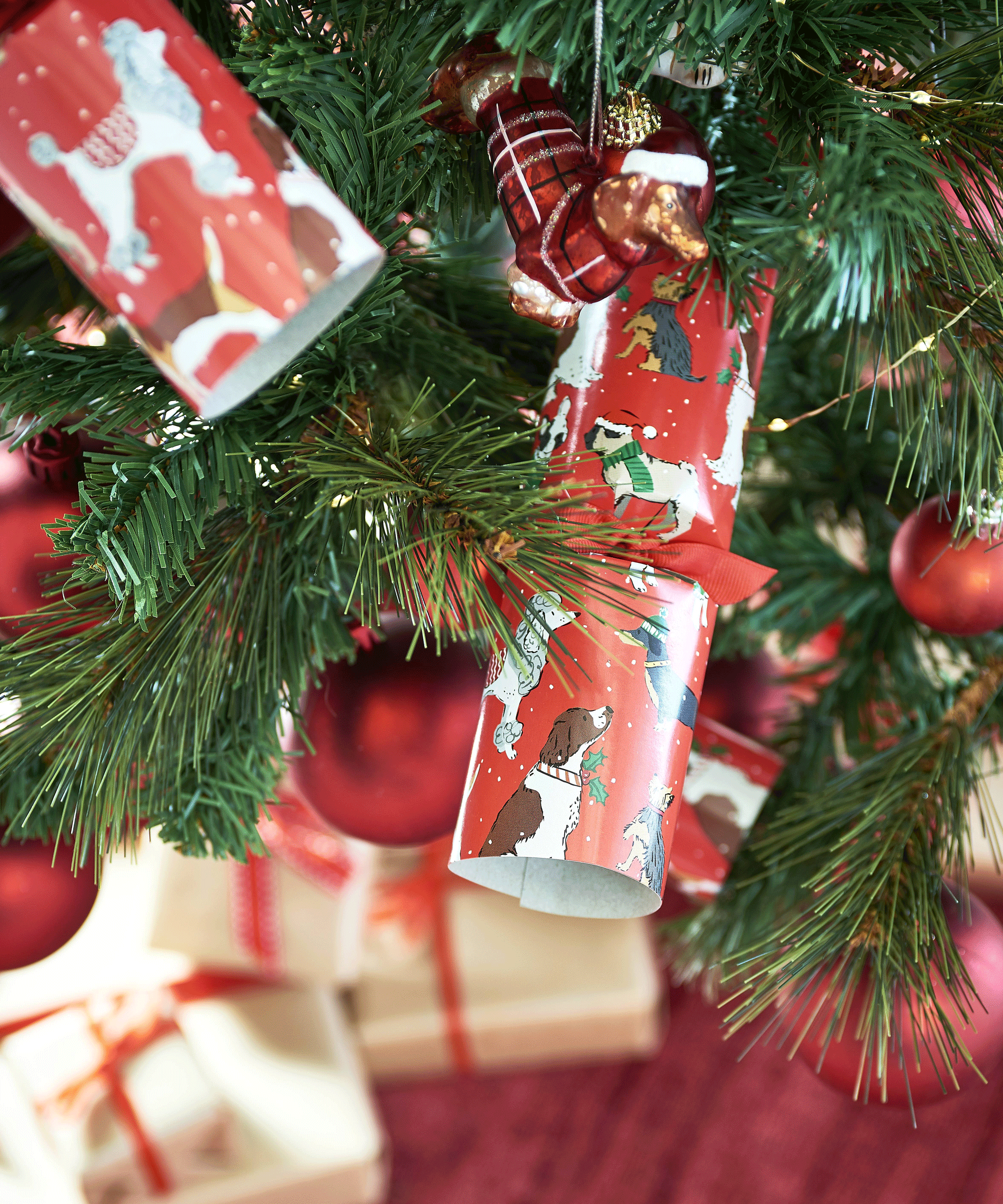 christmas tree decorated with red baubles and crackers