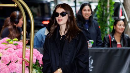 Kaia Gerber wearing head-to-toe black and Nike sneakers while at the Carlyle Hotel in New York City May 2024