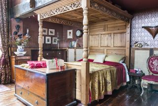 Christmas bedroom with four-poster in converted schoolhouse