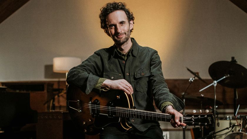 A photo of Julian Lage holding his Gibson ES-225