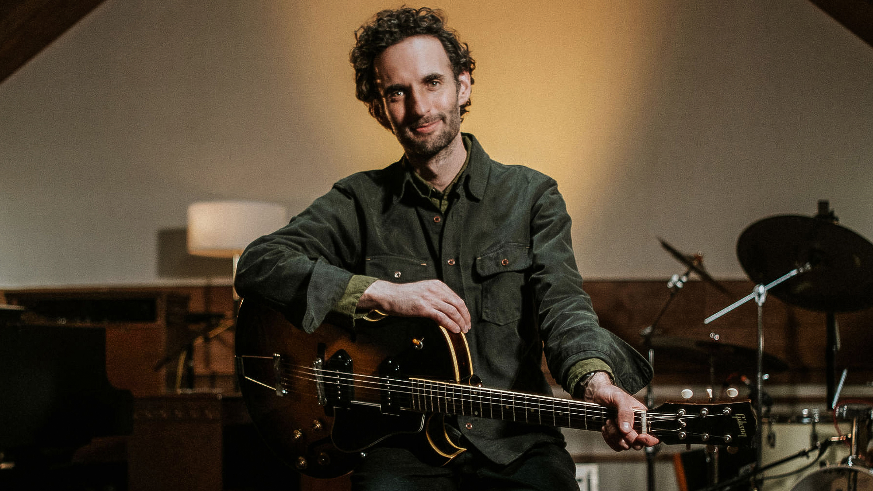 A photo of Julian Lage holding his Gibson ES-225