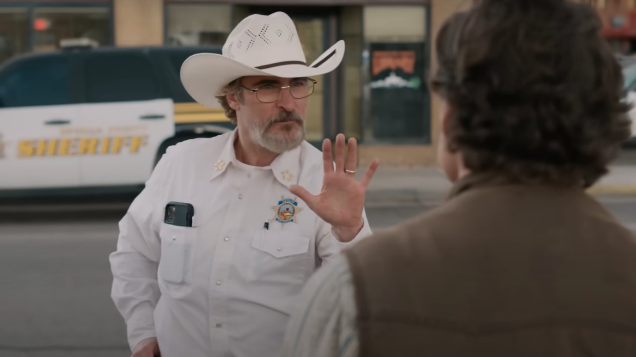 Joaquin Phoenix as sheriff Joe Cross, puts his hand up as he speaks to Mayor Ted Garcia in Eddington.