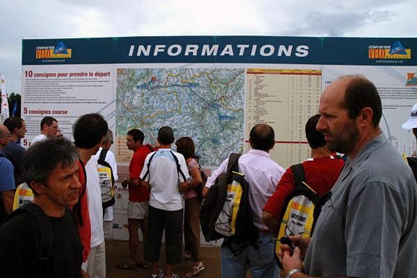 Riders scrutinise the information boards.