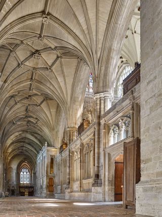 North Aisle toward the north east chapel, Winchester Cathedral: The presbytery aisles. Thomas Bertie’s choir screens are dated 1525 and are surmounted by six mortuary chests.