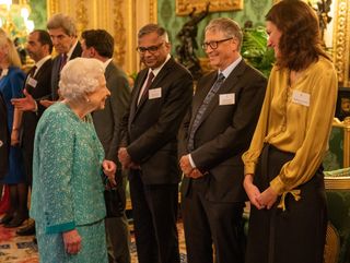 Queen Elizabeth greets Microsoft co-founder turned philanthropist Bill Gates (2nd, R) and Darktrace’s co-founder and CEO Poppy Gustafsson