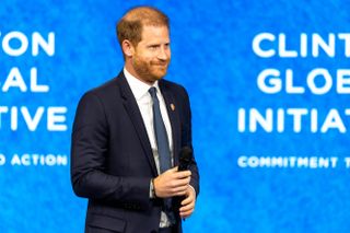 Prince Harry in a suit speaking at the Clinton Global Initiative