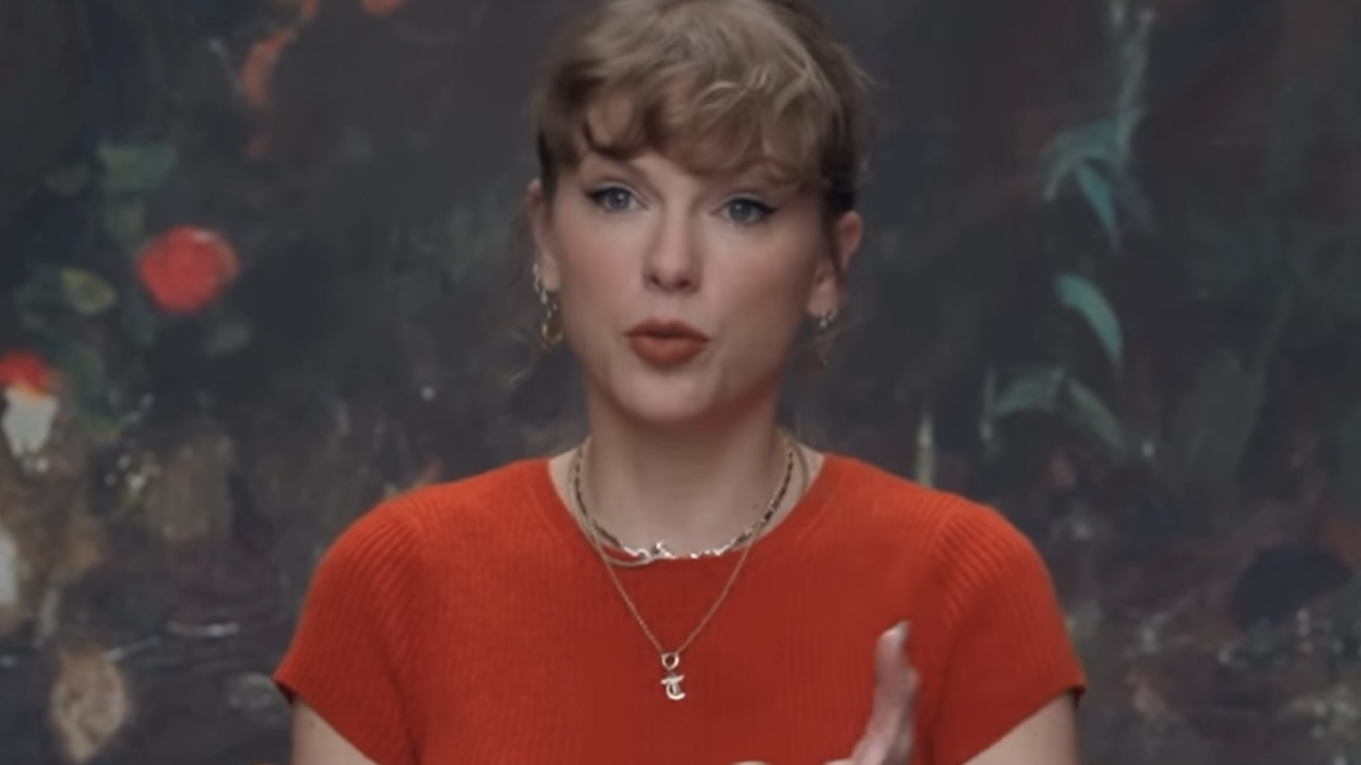 Taylor Swift wears a Showgirl orange Reformation cashmere sweater
