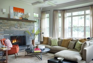 A transitional style living room with orange accents