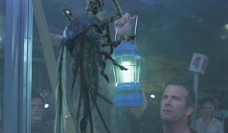 The Mist Thomas Jane holds a lantern to one of the bugs outside the store