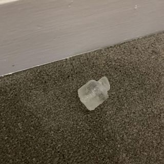 Carpet on flooring with ice cube and white wall