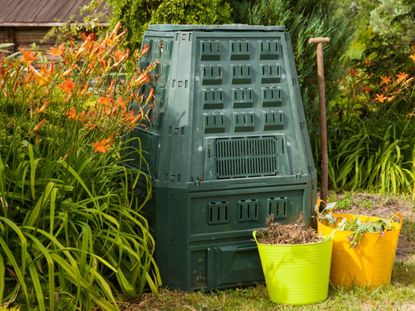 Two buckets of yard waste and a compost bin