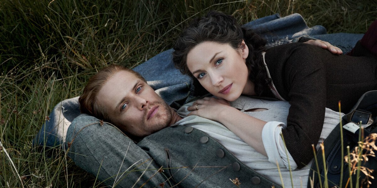 outlander season 5 jamie claire lying in grass starz