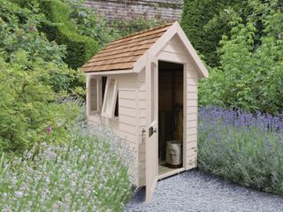 Garden shed with herbs growing either side of it