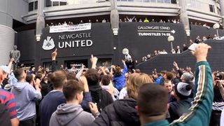 Jubilant Newcastle United fans celebrate the club’s Saudi takeover outside the stadium