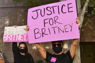 Protesters hold signs at the #FreeBritney protest outside of the courthouse on October 14
