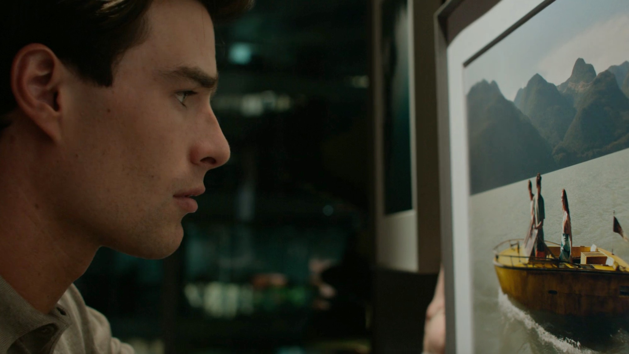 Charlie looking at the One Golden Summer photo in Every Year After.