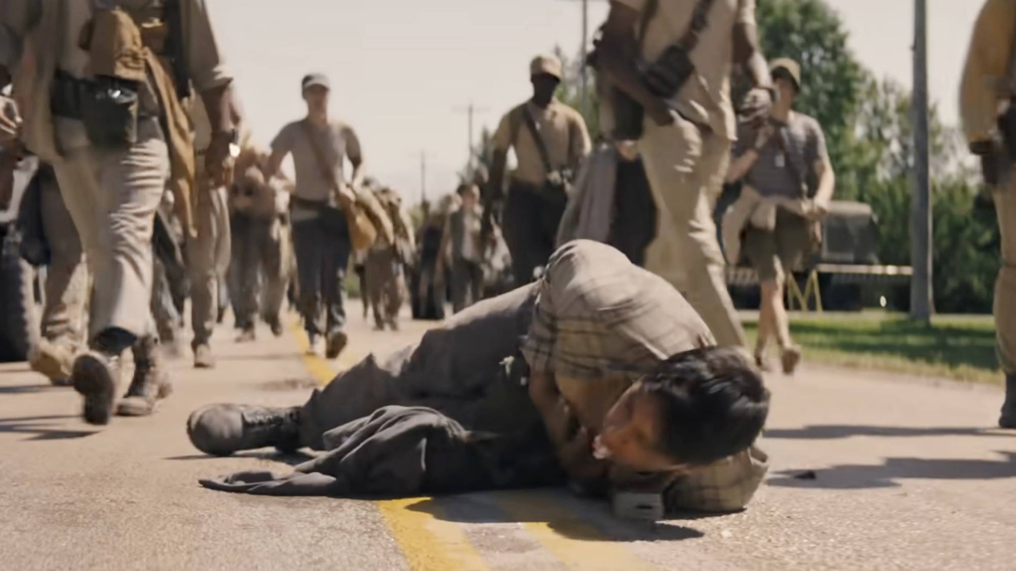 A person convulsing on the ground in The Long Walk
