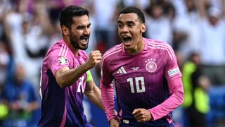 Germany's Jamal Musiala celebrates with captain Ilkay Gundogan after scoring against Hungary.