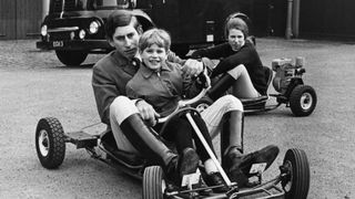 King Charles riding a go-kart with Prince Edward