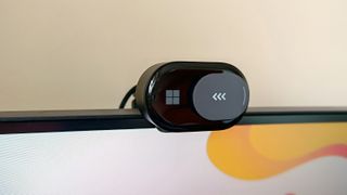 A black Microsoft Modern Webcam perched on a monitor