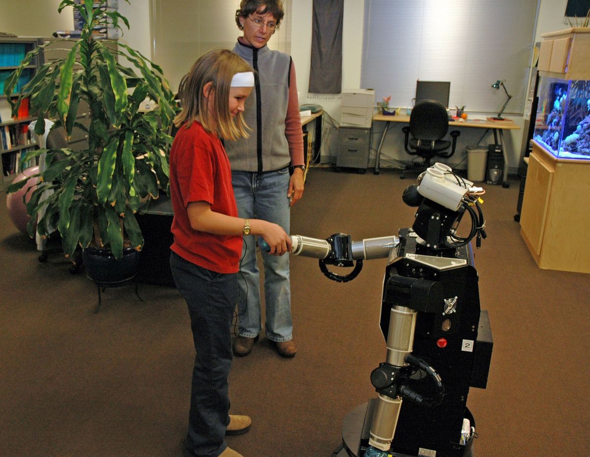 A child interacting with Robovie, a remotely controlled humanoid robot. 