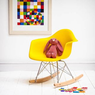 yellow rocking chair on wooden floor