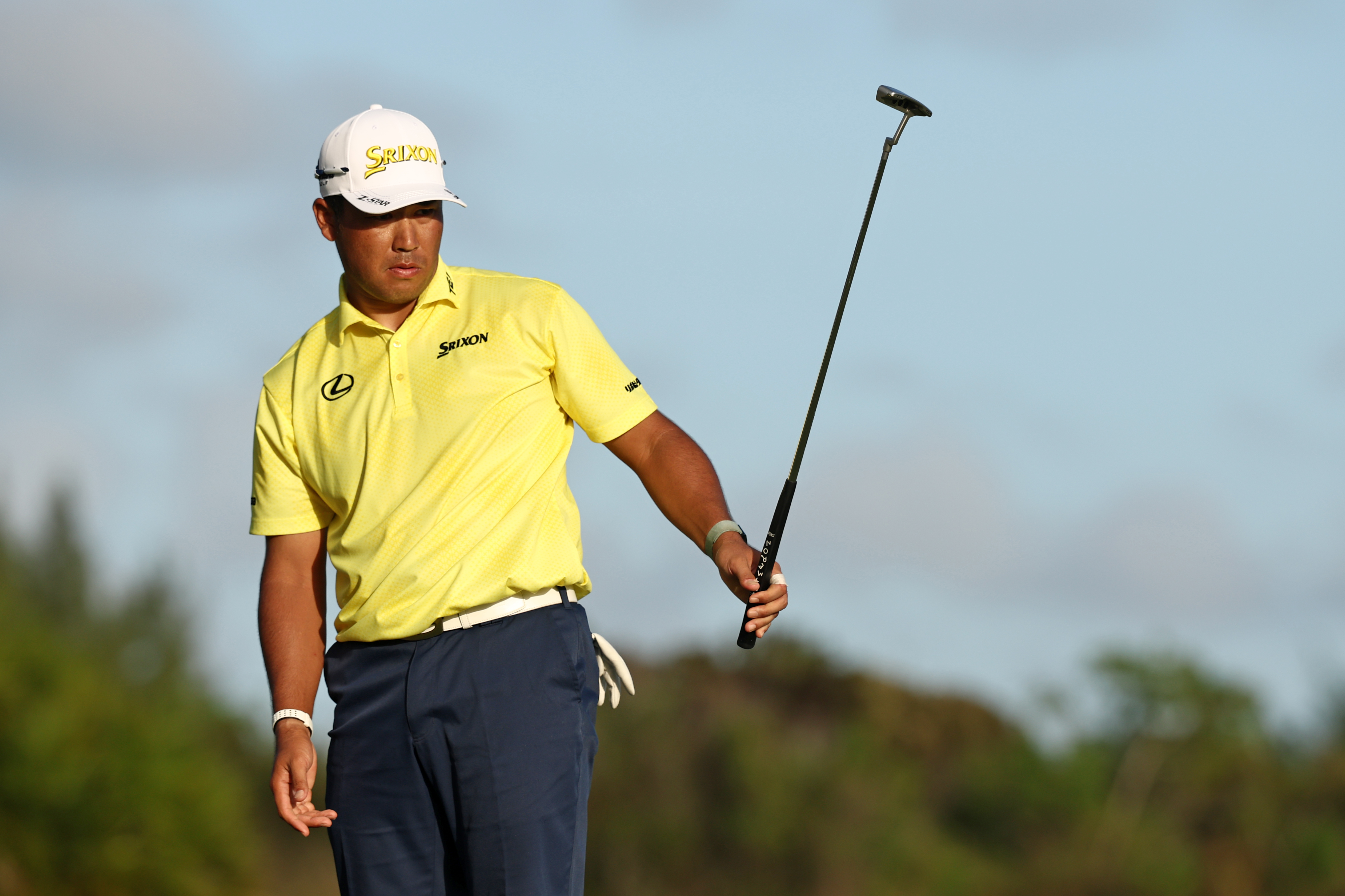 Hideki Matsuyama raises his putter in the air