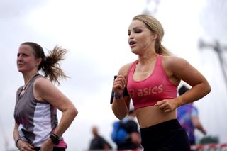 TV presenter and activist Katie Piper (right) crosses Westminster Bridge in central London as she takes part in the Asics London 10k, thought to be the largest closed road running event in London since the March 2020 lockdown. Picture date: Sunday July 25, 2021.