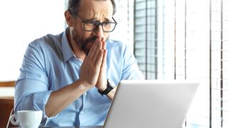 Man looking in hope at a laptop