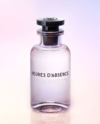 Bottle of heures d'absence perfume against a light pink and purple background