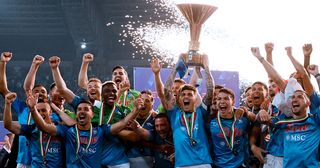 Serie A Season Preview: Napoli's Italian defender Giovanni Di Lorenzo (C) holds the Italian Scudetto Championship trophy as he and his teammates celebrate winning the 2023 Scudetto championship title on June 4, 2023, following the Italian Serie A football match between Napoli and Sampdoria at the Diego-Maradona stadium in Naples.