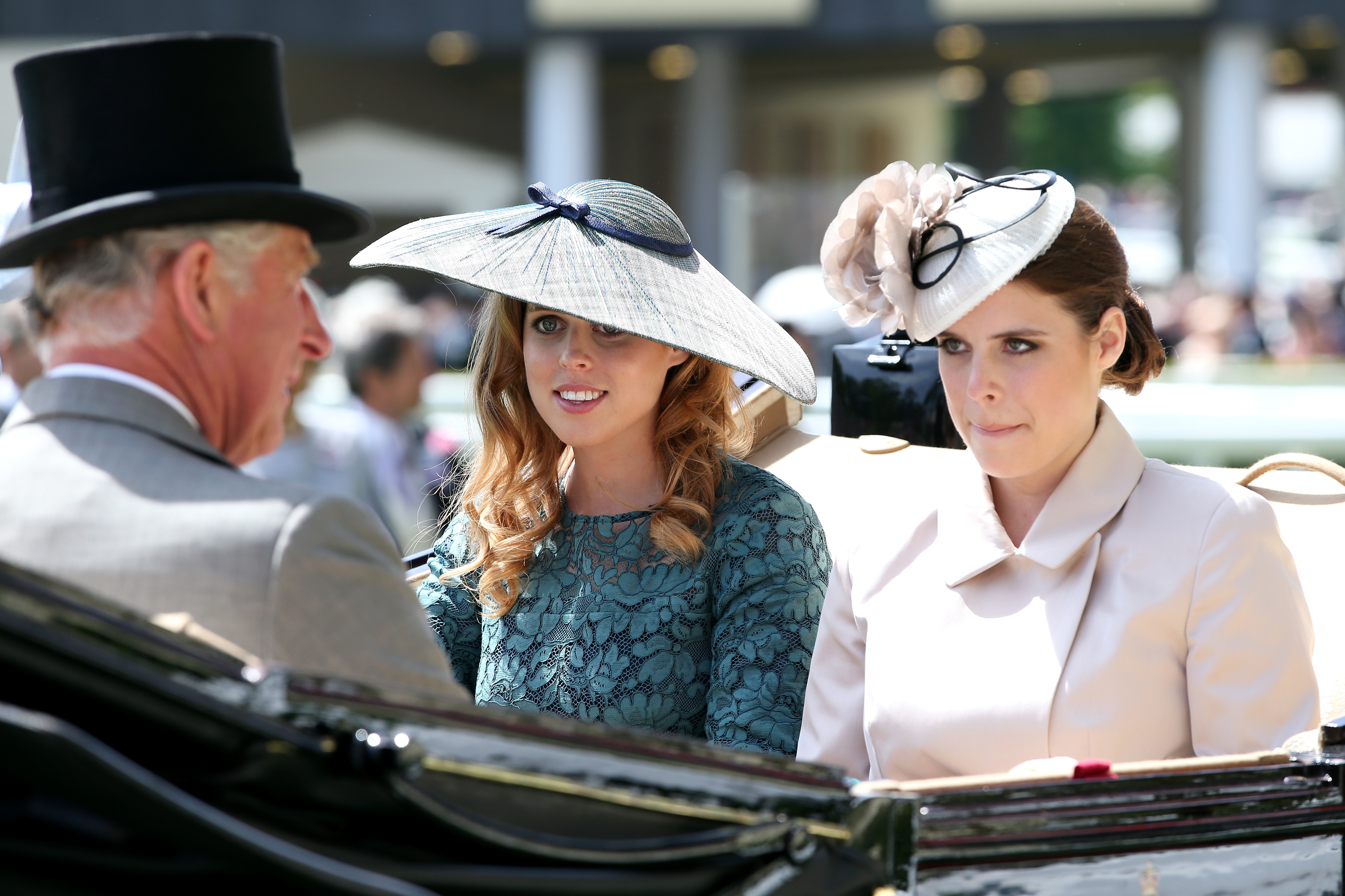 King Charles riding in a carriage with Princess Eugenie and Princess Beatrice