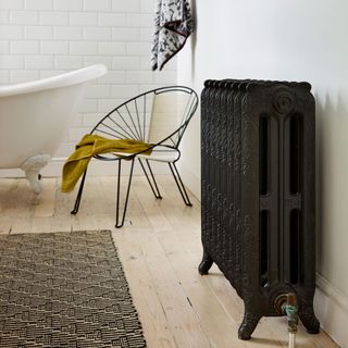 bathroom with black radiator and white bathtub