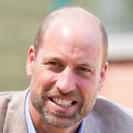 Prince WIlliam smiling in a suit outside