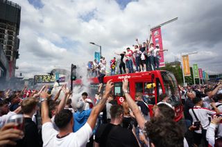 England fans climb aboard a bus outside Wembley