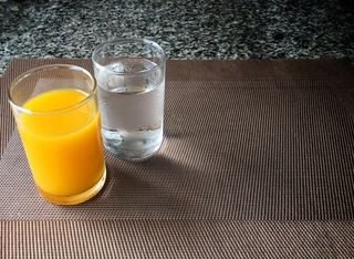 Glasses of orange juice and water.