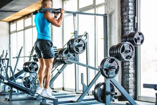 Man using calf raise machine in gym