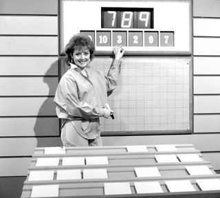a black and white photo of Carol Vorderman next to the Countdown numbers board