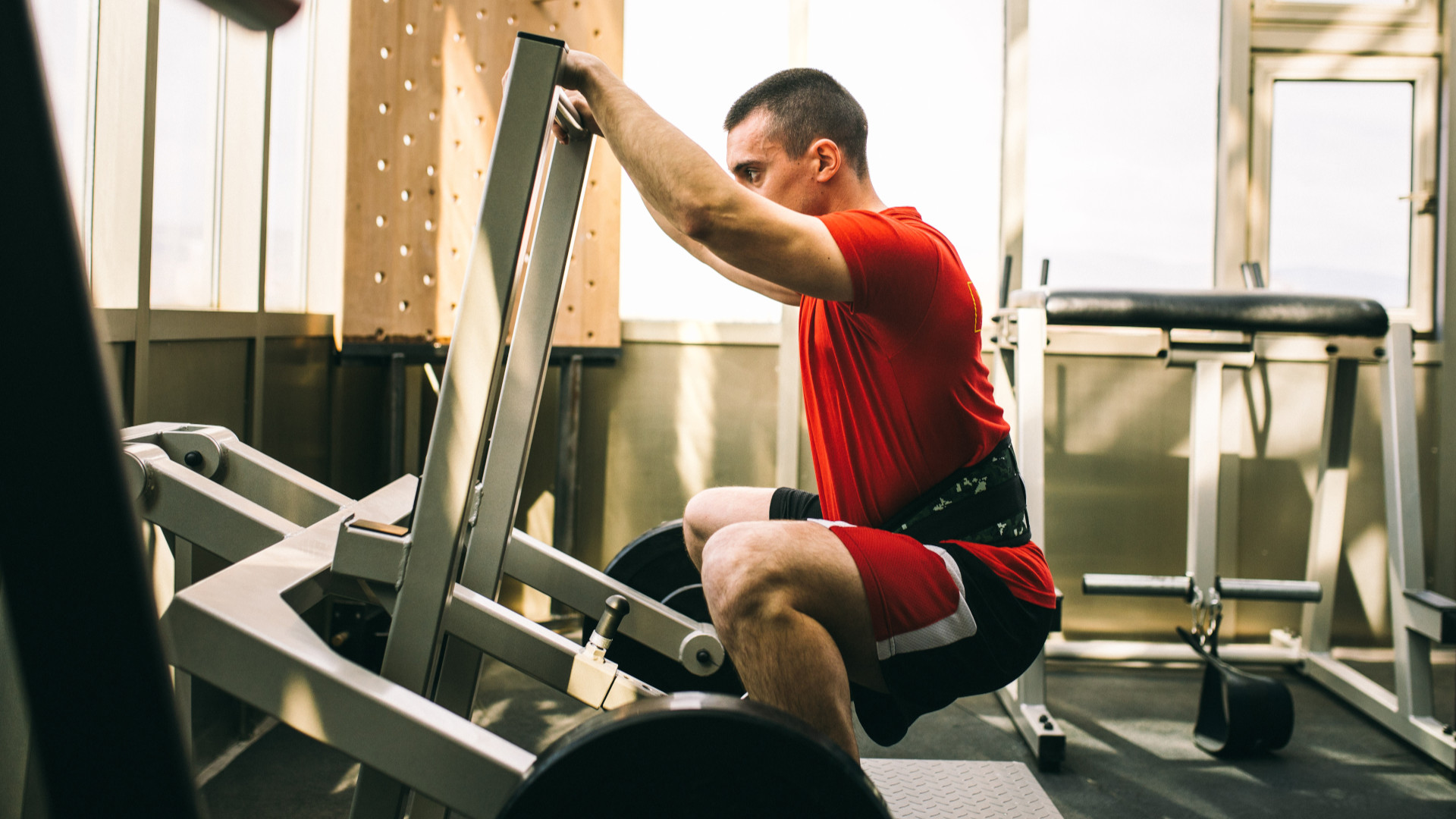Belted squat machine